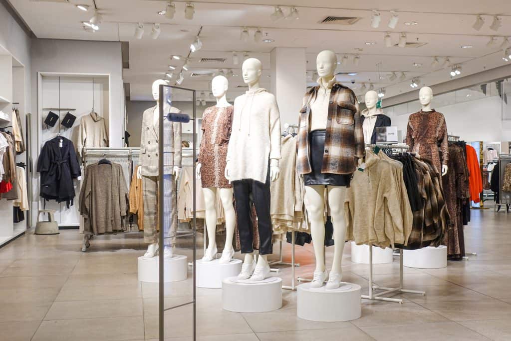 clothes on rack in a store with fast fashion problems and fast fashion environmental concerns.  