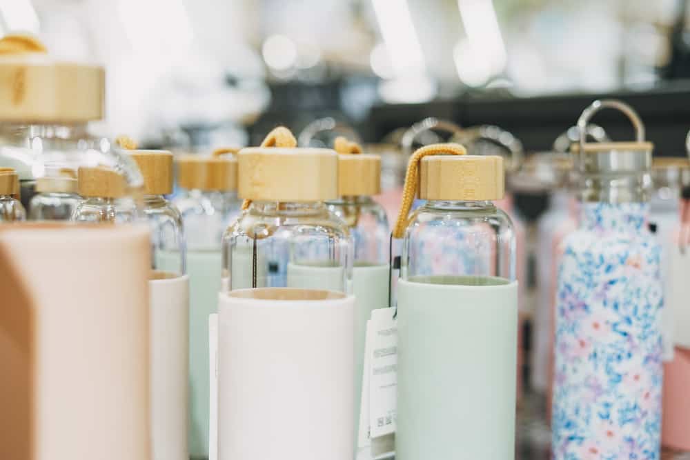 Glass eco-friendly water bottles on the counter in store