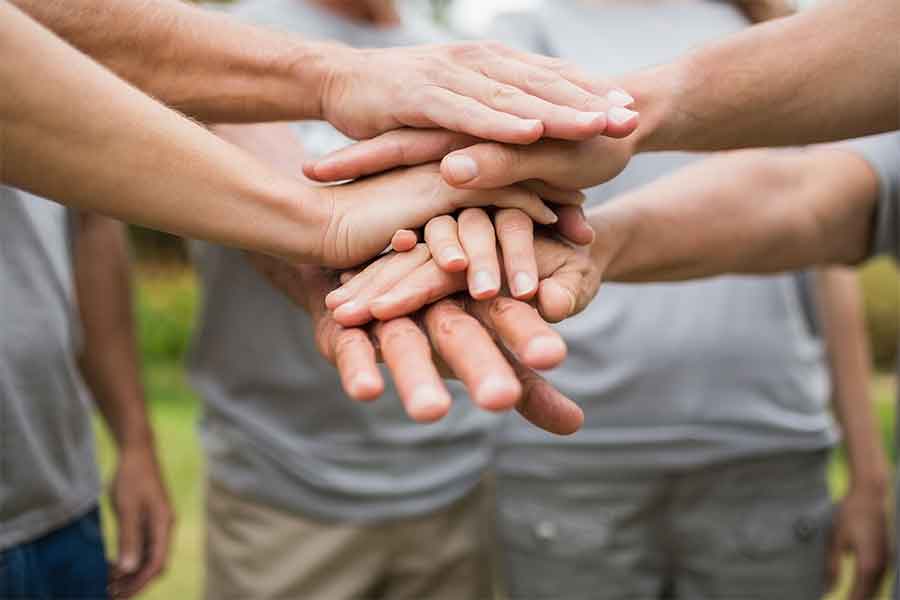 Hands stacked on top of each other in a group